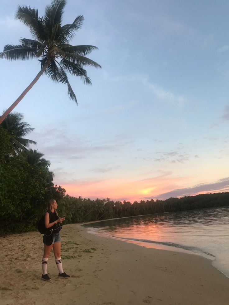 Australian Survivor TV producer working on beach at sunset